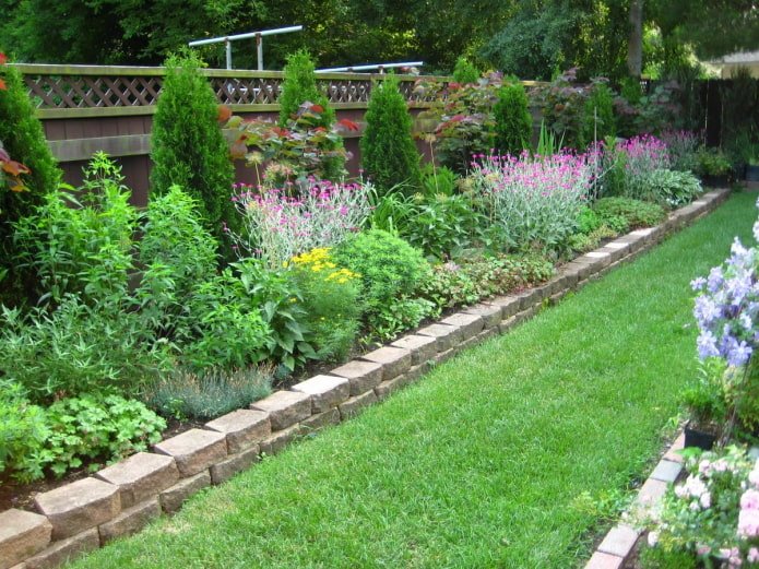 gemischtes Blumenbeet am Zaun