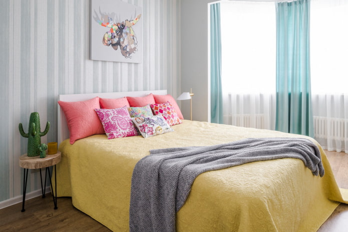 Bett mit einer gelben Tagesdecke im Schlafzimmer